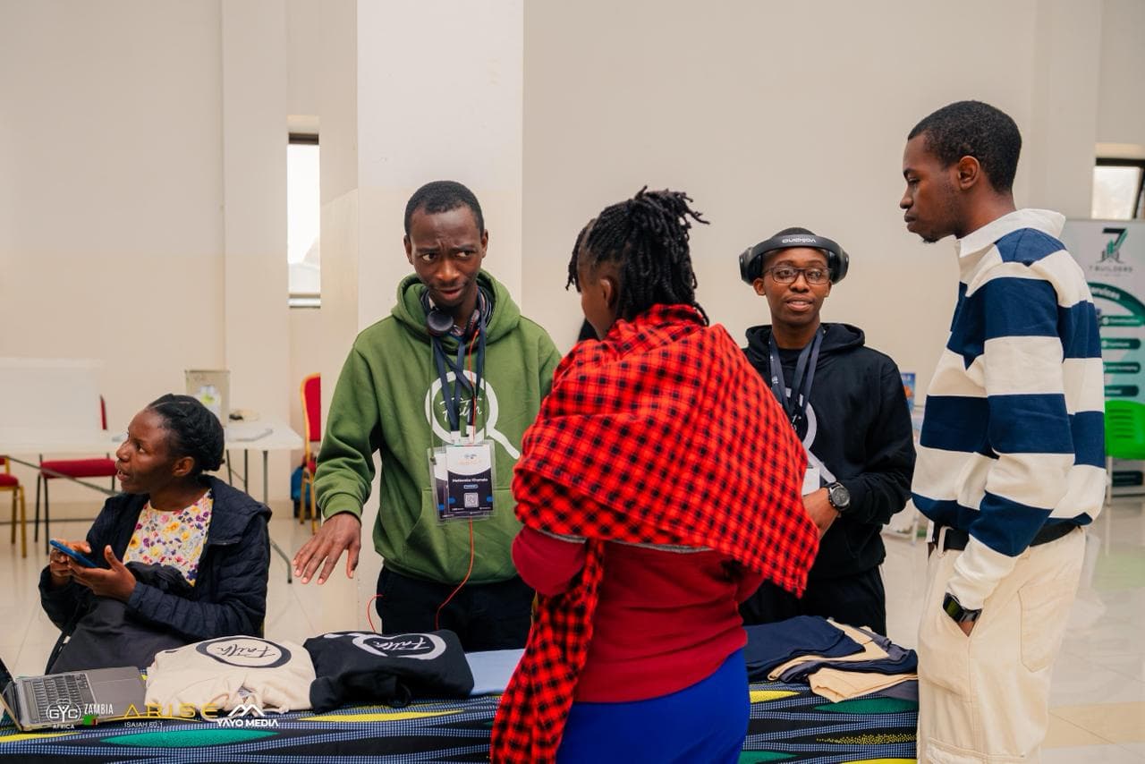 People gathered in conversation around the FaithExplored stand at GYC Africa 2026