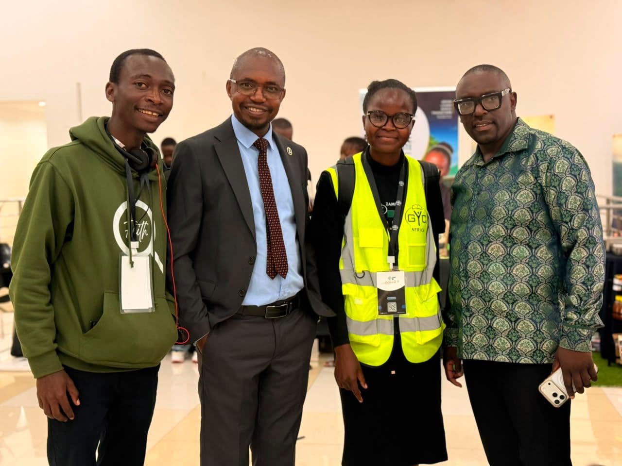 Four conference attendees posing together inside the GYC Africa venue